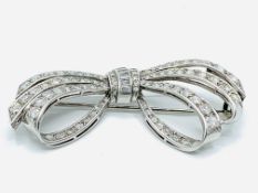 18ct white gold brilliant and baguette cut diamond openwork bow brooch.