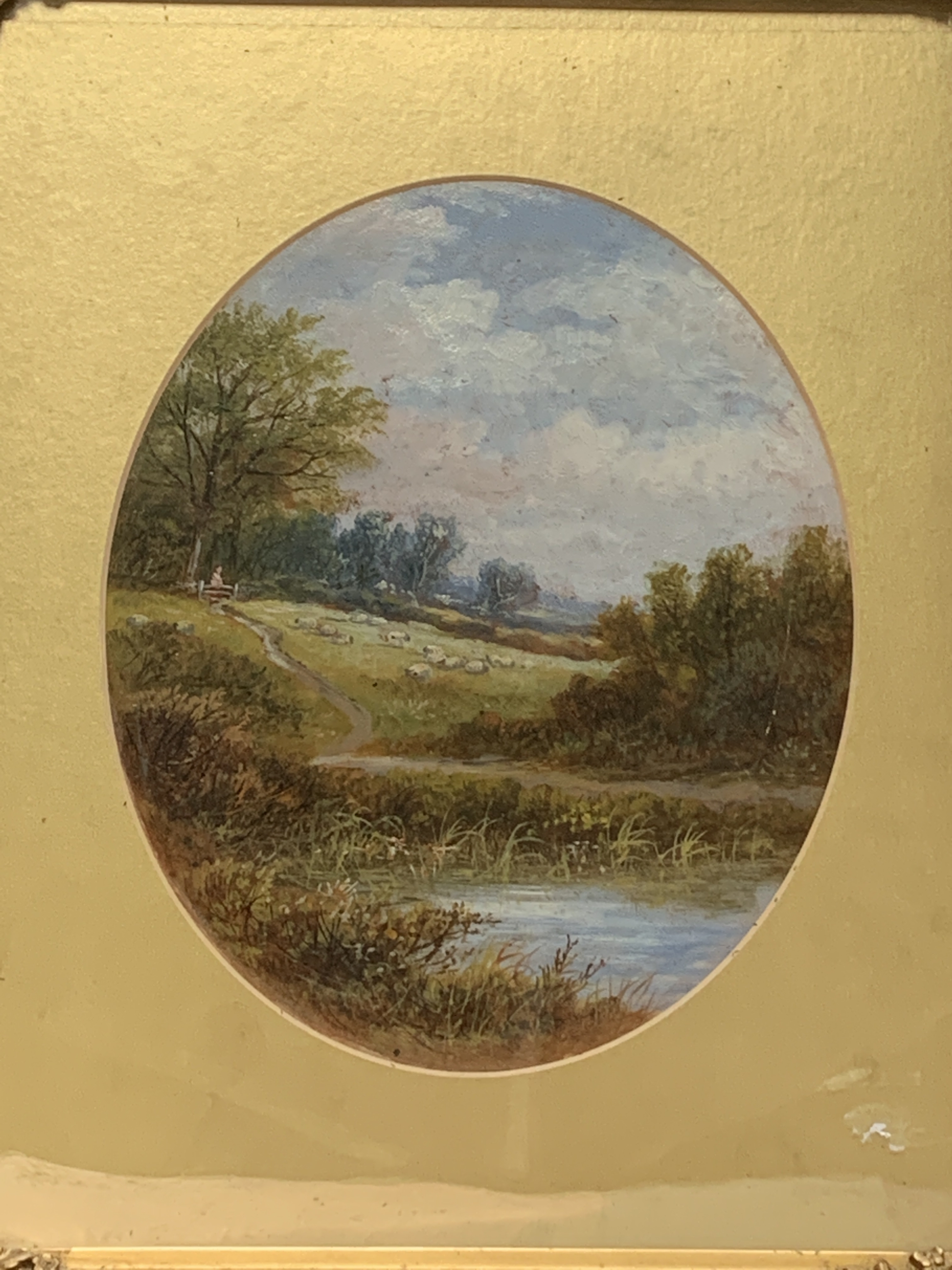 A pair of gilt framed and glazed oval mounted oil paintings