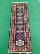 Blue ground Kazak runner and a red ground hand-knotted rug