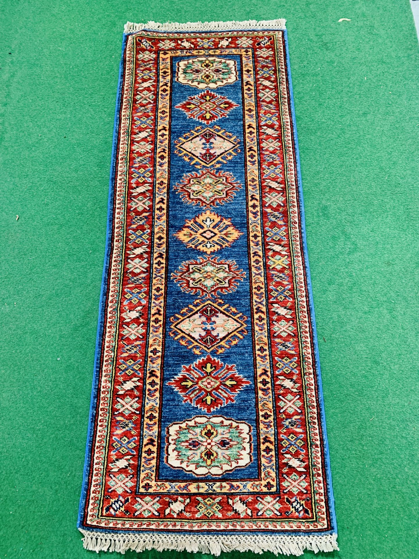 Blue ground Kazak runner and a red ground hand-knotted rug