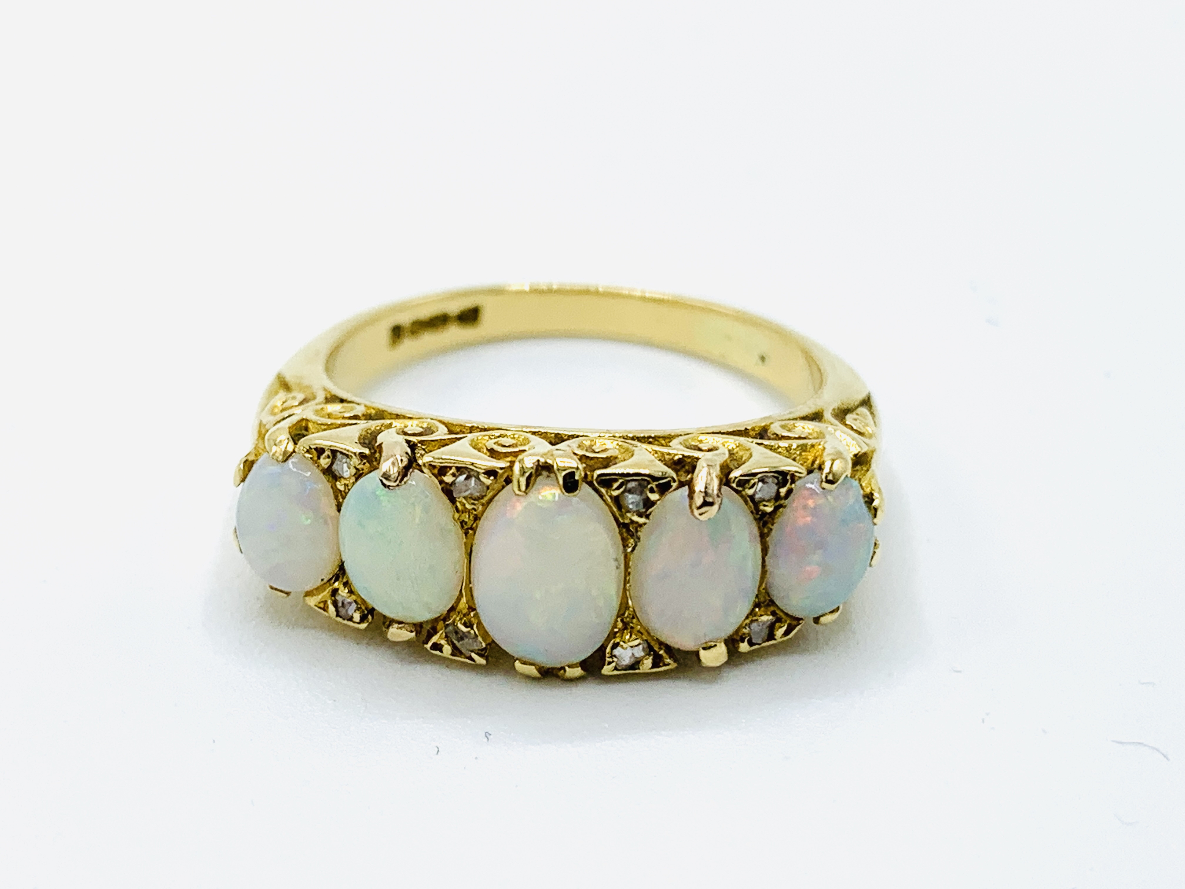 18ct yellow gold ring with five graduated opals in filigree setting
