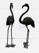 Two black painted metal figures of flamingos