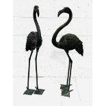 Two black painted metal figures of flamingos