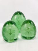 Three Victorian pale green "end of day" glass paperweights