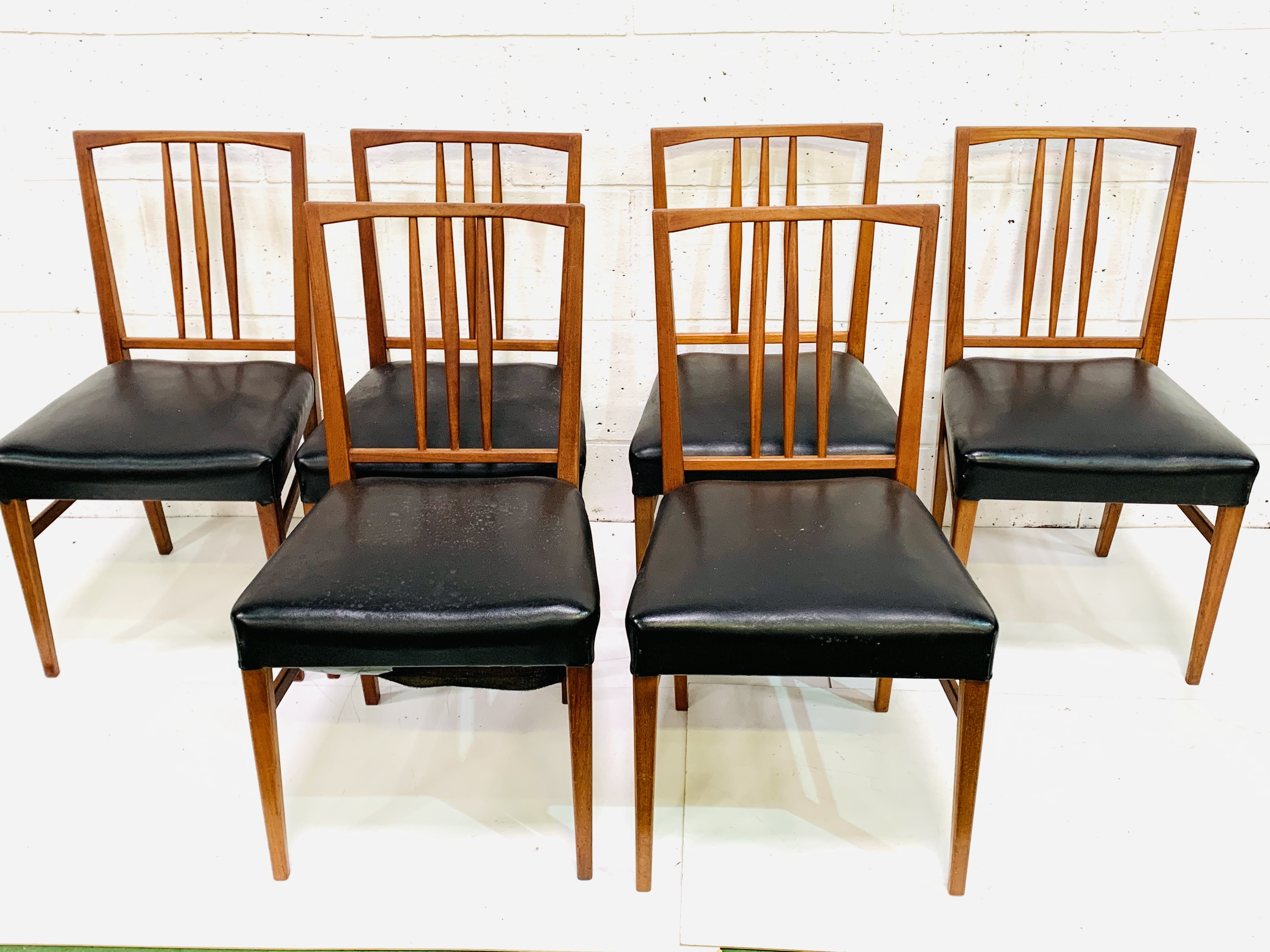 A group of 6 teak framed rail back chairs