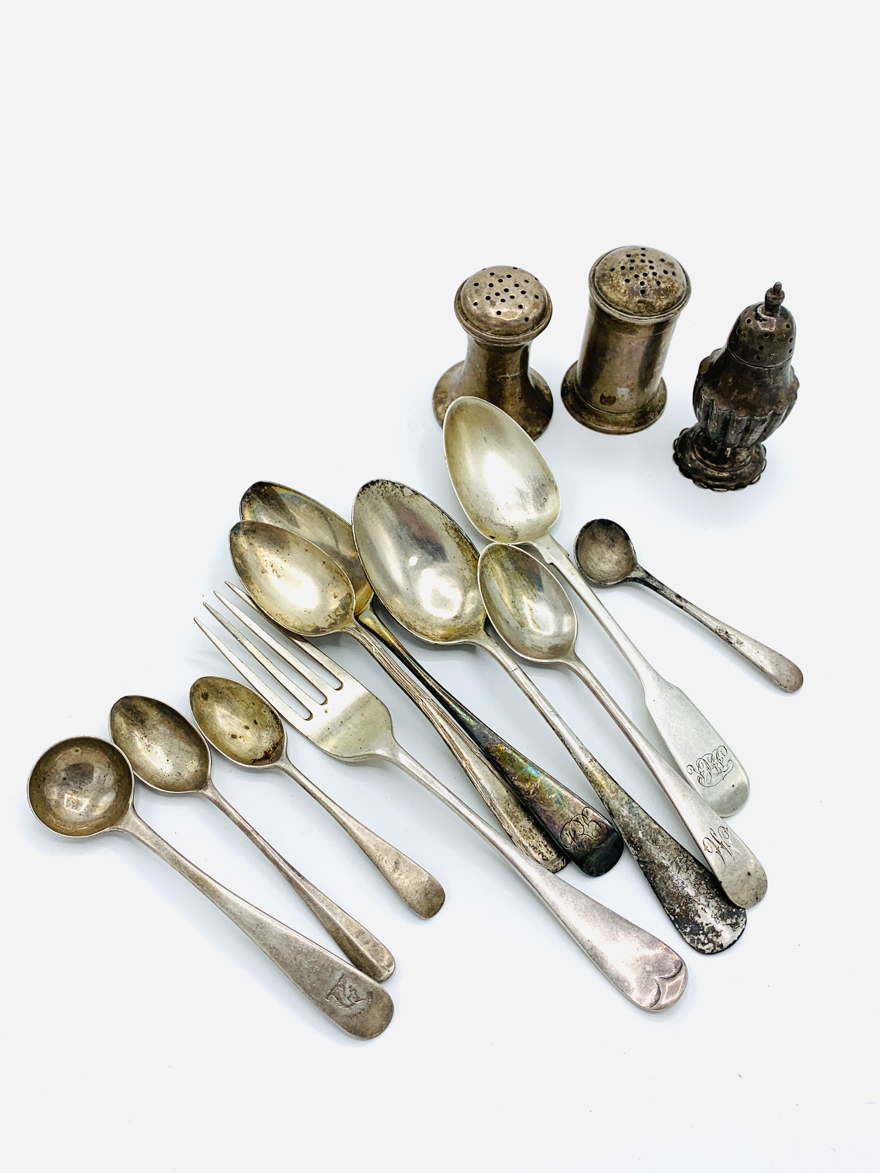 A collection of silver condiment and teaspoons; a silver fork; an 800 silver spoon; and 3 cruets.