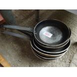 Eight frying pans