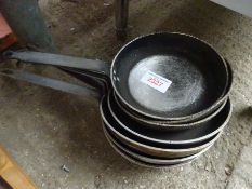 Eight frying pans