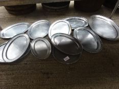 Eleven stainless steel serving trays