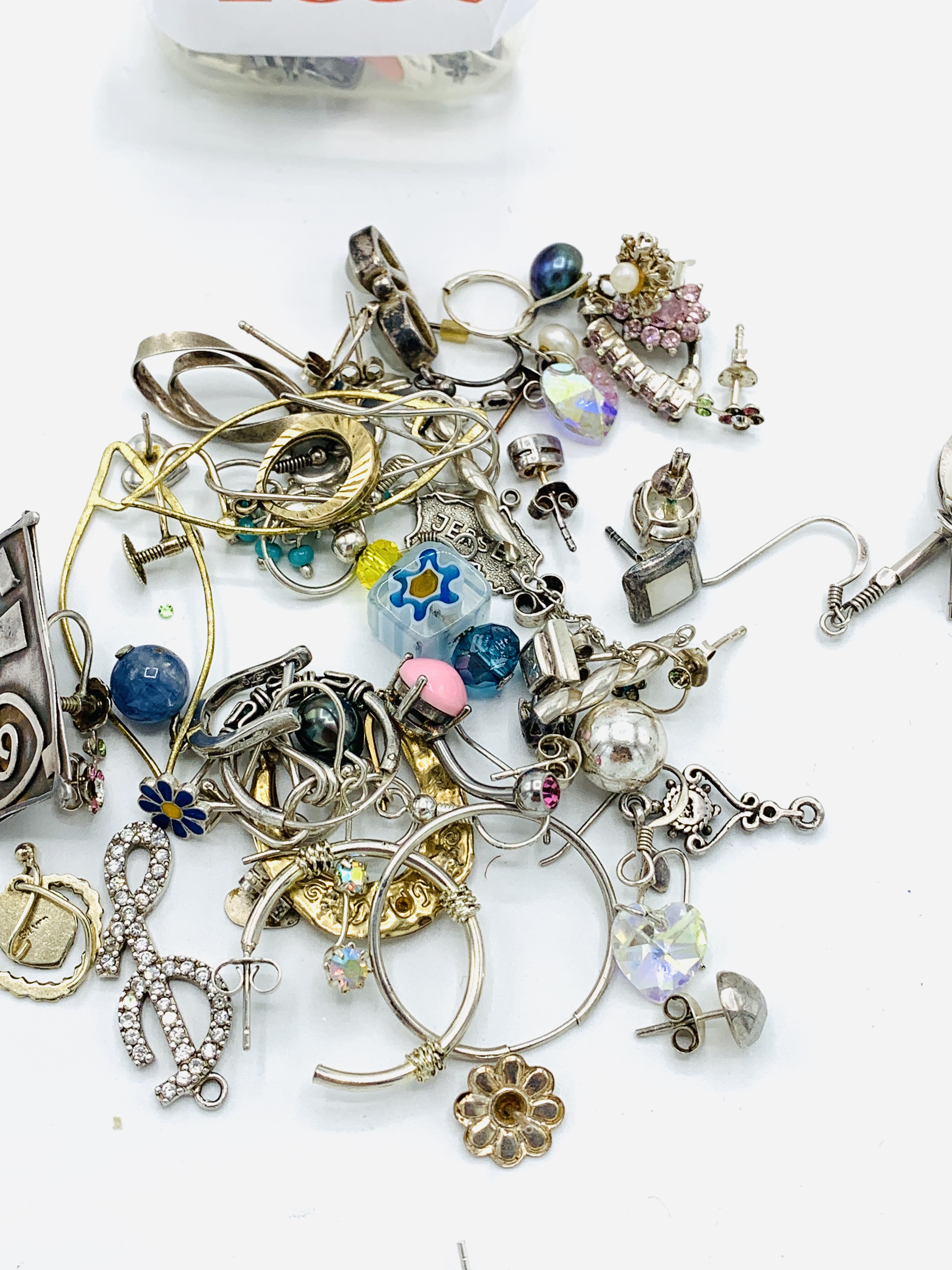 Quantity of 925 silver charms, pendants, and single earrings, some with stones