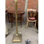 Columned brass lamp standard on square base to claw feet