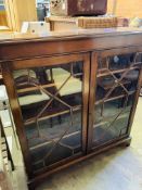 A mahogany glass fronted bookcase