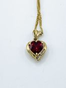 9ct gold red stone and diamond pendant on a 9ct gold chain