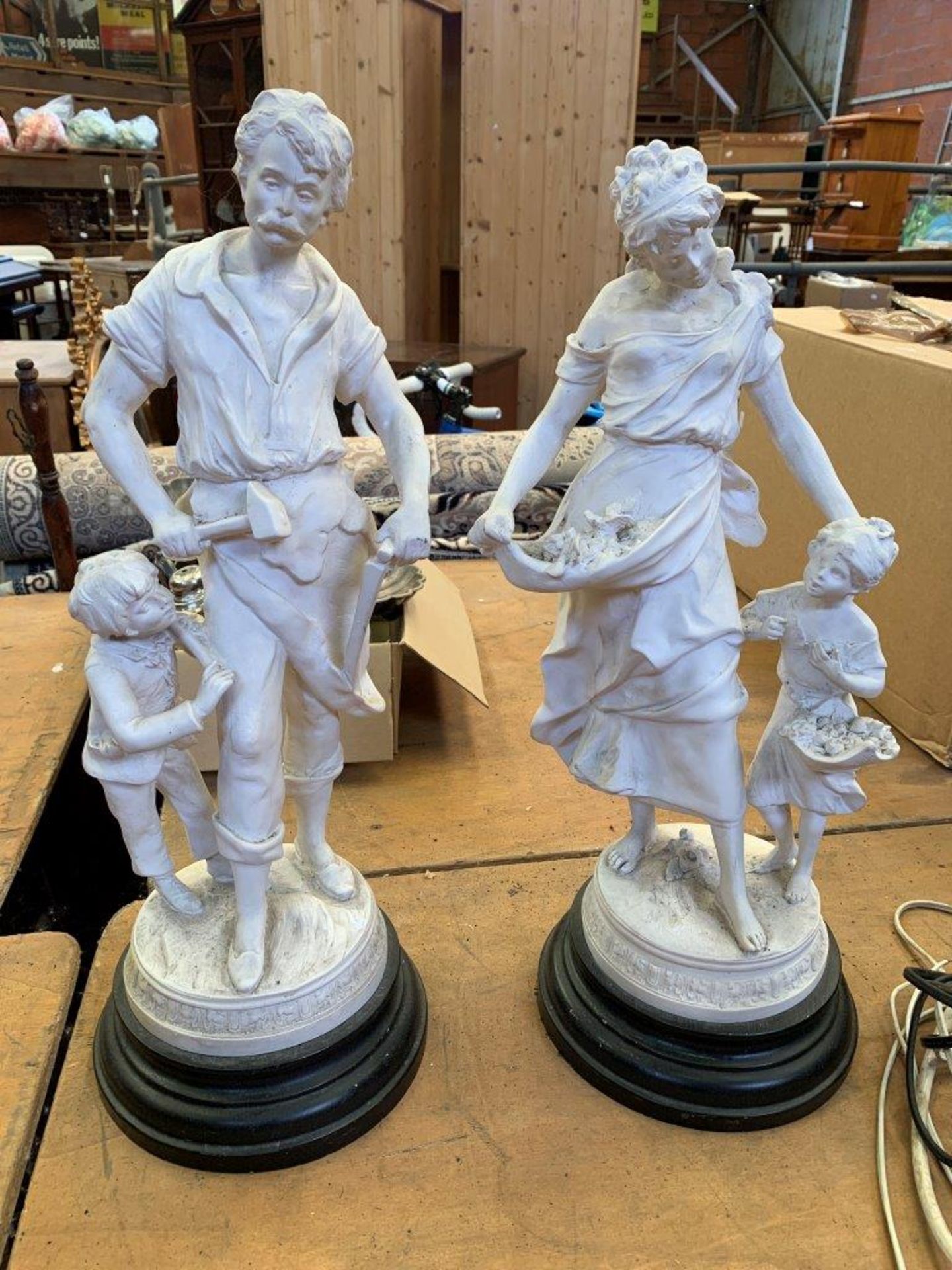 Parian figure of a flower seller with girl together with one of a Blacksmith with boy