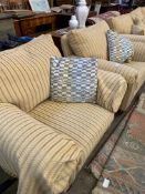 Two armchairs upholstered in gold coloured striped fabric