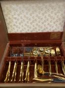 A wooden canteen of gold plated cutlery by Rogers