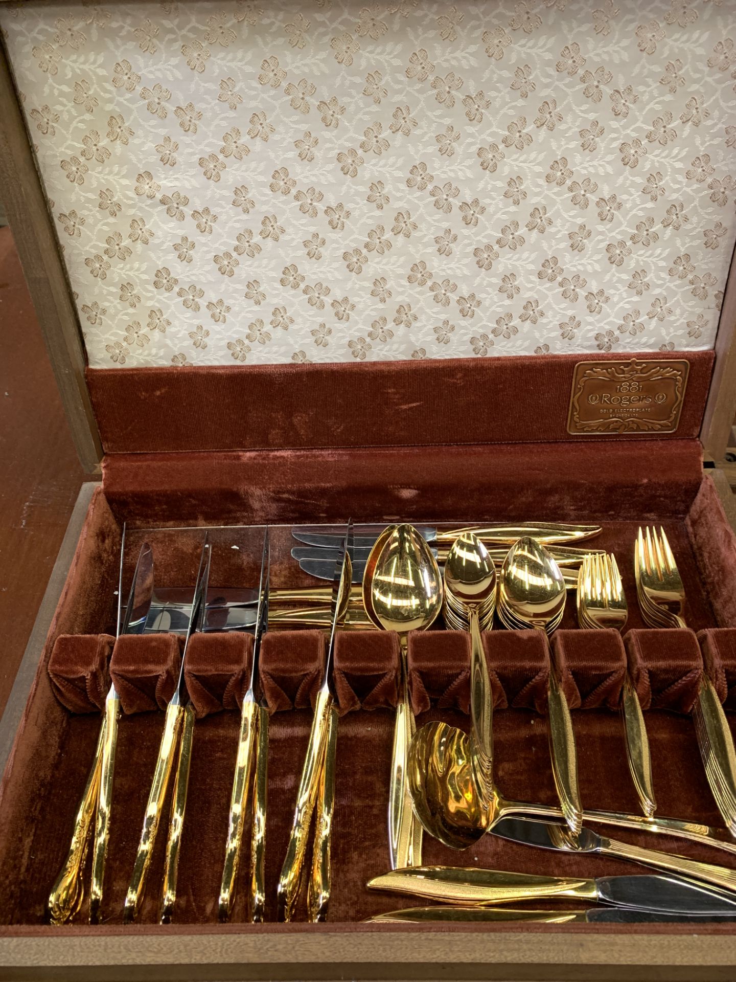 A wooden canteen of gold plated cutlery by Rogers