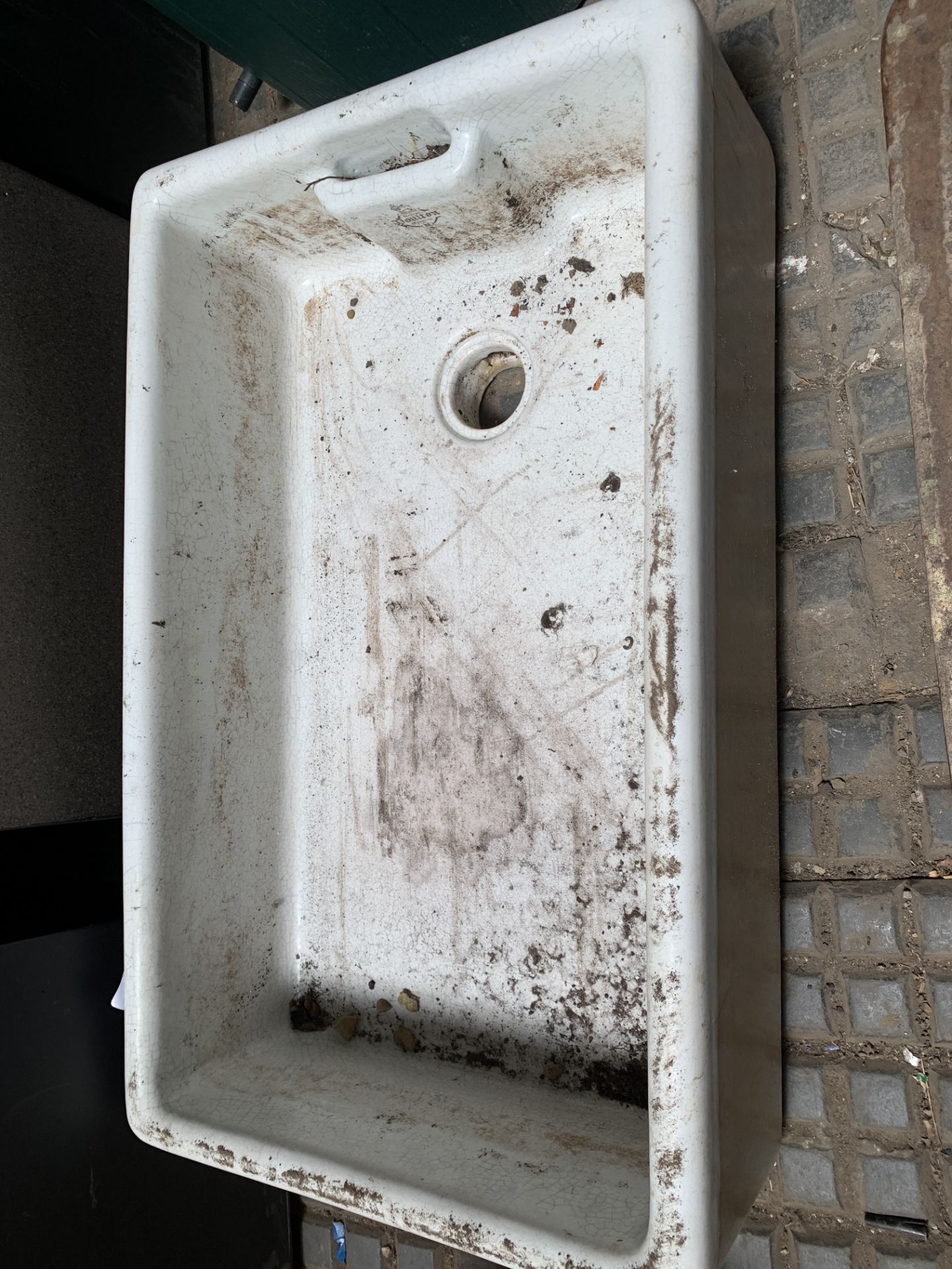 A white glazed stoneware Belfast sink