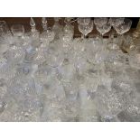 A large quantity of cut glass drinking glasses