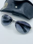 Pair of Ray Ban sunglasses in leather effect Ray Ban case