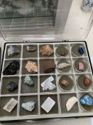 Two trays comprising a collection of thirty nine various rock crystals and polished stones