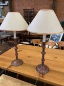 A pair of decorative candle stick-shaped metal table lamps