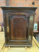 An early 19th century mahogany wall cupboard