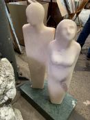 Sculpture of a couple on a green marble plinth, by Fiona Goldbacher