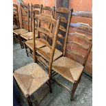 Six oak framed high ladder back chairs with string seats