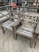 Two teak garden armchairs