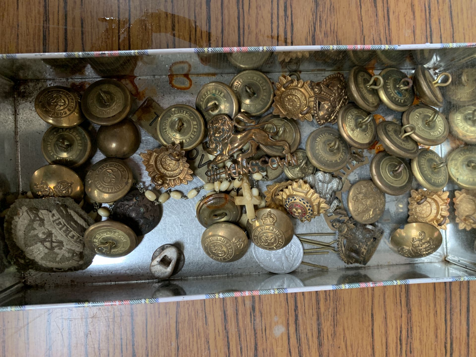 A collection of brass military buttons and badges