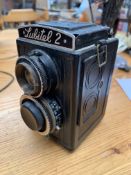 Collection of antique cameras: Lubitel, Ica, and Kodak