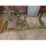 Brass fender with rope twist decoration, 138cms; two brass firedogs; two brass fire irons.