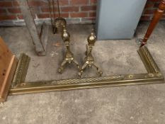 Brass fender with rope twist decoration, 138cms; two brass firedogs; two brass fire irons.