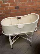 A white painted 1930s style baby's crib on stand