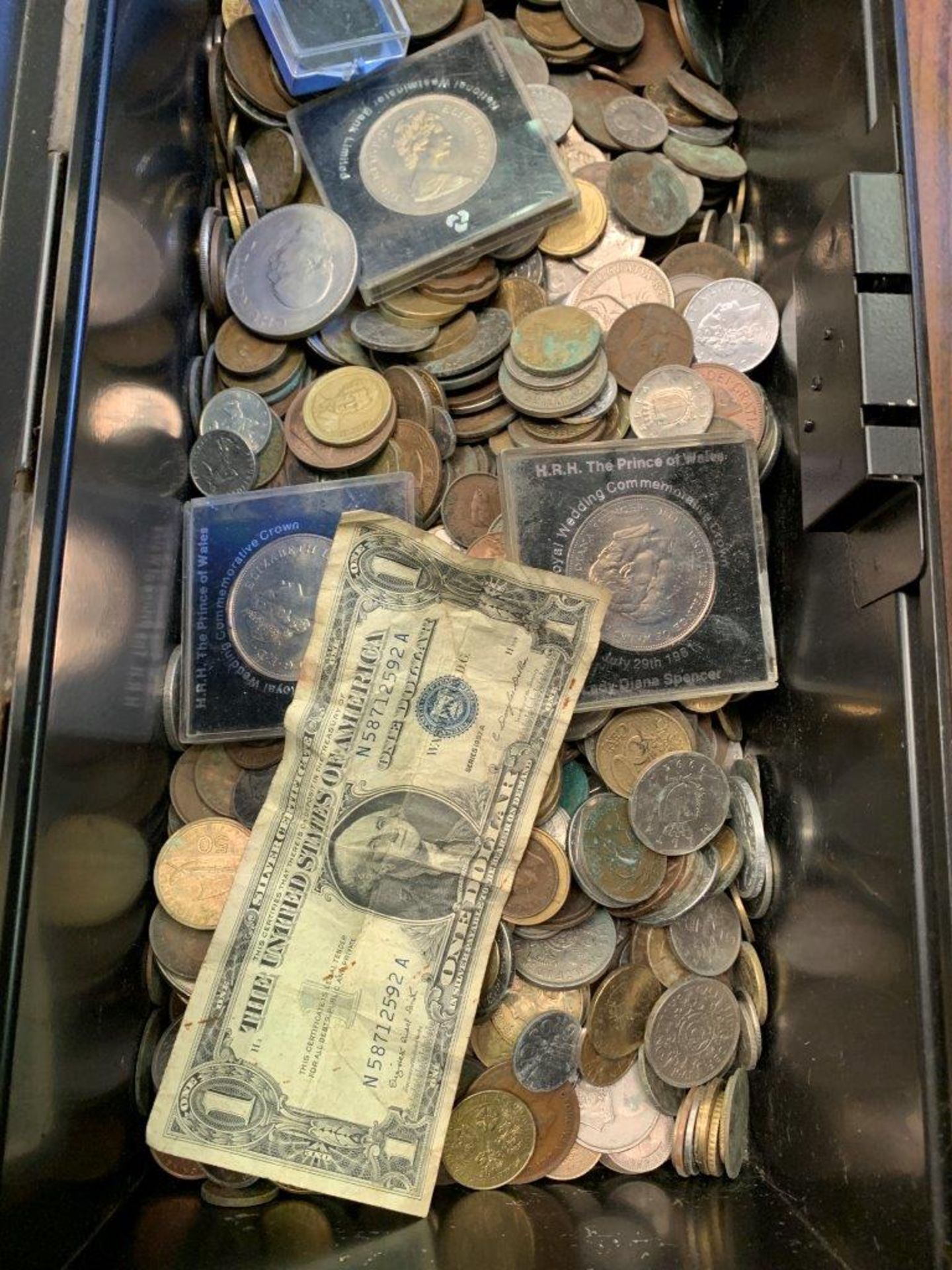 Black metal box containing a large quantity of GB and foreign coins