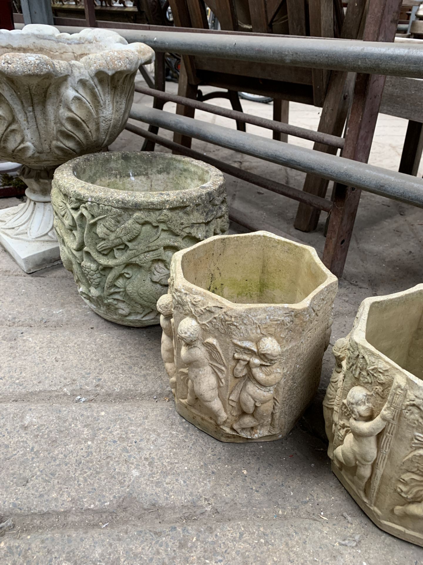 A pair of planters, another planter, and a jardiniere
