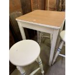 Square white painted kitchen table and three round top white painted stools