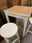 Square white painted kitchen table and three round top white painted stools