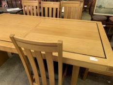 Oak extendable dining table with two leaves together with six oak framed rail back dining chairs