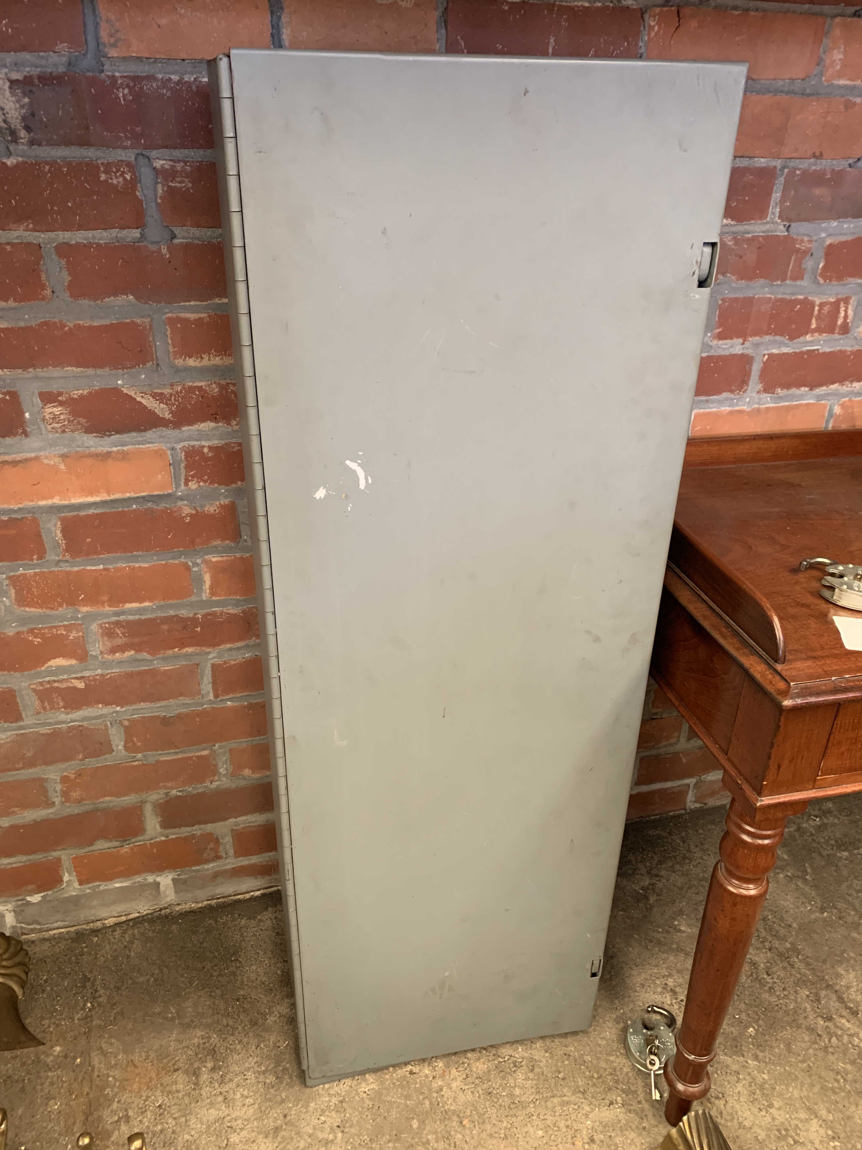 Grey painted metal wall mounted cabinet complete with two padlocks and keys