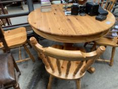 Circular pine pedestal table together with four pine chairs