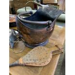 Copper coal scuttle, brass lamp, two ceramic bookends and a pair of bellows