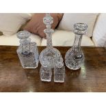 Three cut glass decanters and 2 vinegar bottles