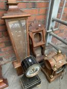 Table clock with visible escapement with another table clock and two clock cases.