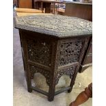 Octagonal table with African style carvings to the top