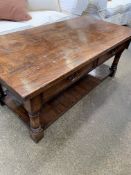 A low oak table with a shelf beneath