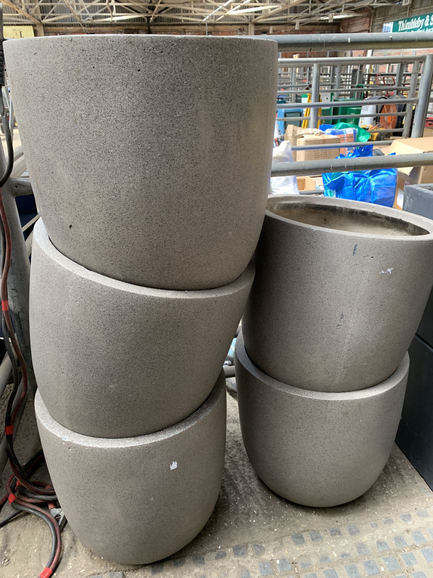 Five round stone-effect fibreglass planters