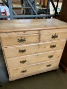 Pine chest of two over three graduated drawers on bun feet