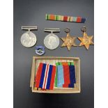 Four WWII medals, complete with ribbons, in original postal box dated 1949
